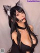 A woman with long black hair wearing a cat ears headband.